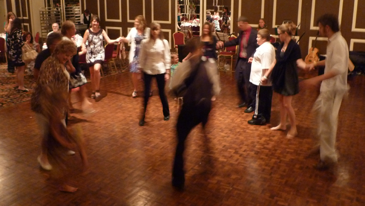 Photo of Band members teaching and leading a dance at a private party. Copyright 2010, Modal Music, Inc. (tm). All rights reserved.